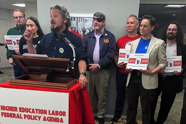 Todd Wolfson, president of the AAUP, speaks at a lectern that says "Higher Education Labor Federal Policy Agenda" on it. 