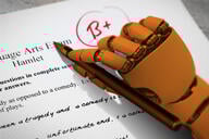 A robot hand grading an essay.