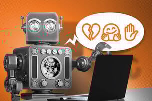 A robot at a computer speaking in emoji.
