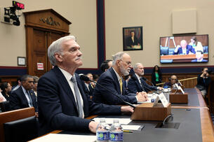 Robert Groves, interim president of Georgetown University; Félix Matos Rodríguez, chancellor of the City University of New York; and Rich Lyons, chancellor of the University of California, Berkeley, testify during a House Committee on Education and Workforce hearing. The three men are sitting at a long table with their name plates in front of them.