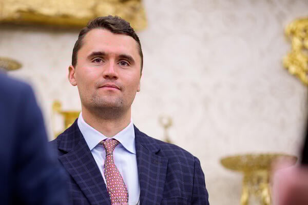 Turning Point USA co-founder Charlie Kirk wearing a suit and tie.