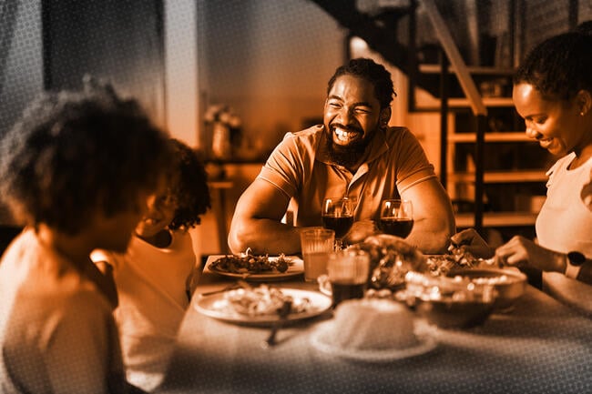 Happy family talking while having lunch in dining room 