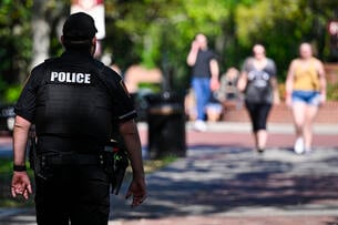 A Florida State University police officer stands on campus.