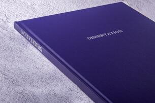 A royal blue bound book with the word "Dissertation" on the cover and spine.