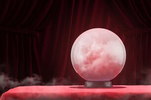 A photo of a glowing crystal ball against a red background.