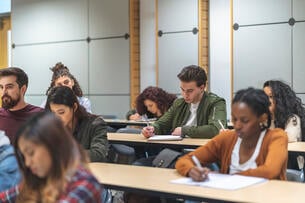 A multiethnic group of students listen in lecture