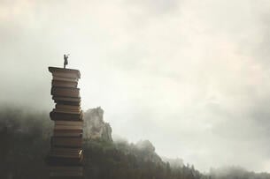 A drawing of a woman standing with a telescope on top of a stack of books in the mountainous outdoors, suggesting education as a path to freedom.