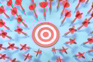 An image of dozens of red darts having missed the target.