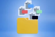 An illustration of a manila file folder with four document files hovering above it.