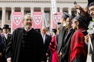 Harvard president Alan Garber, a light-skinned man with gray hair and a beard, wearing academic regalia at Harvard's 2025 commencement.
