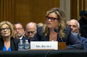 Kimberly Richey, a white woman with blond streaks in her hair, sits at a table in front of an audience during a confirmation hearing on Thursday.