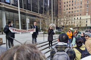 A photograph of a pro-Palestine protest in New York City, including a banner that says "Ceasefire Now!"