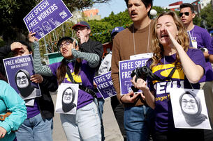 Members of the Service Employees International Union protest against the Trump administration.