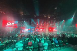 Crowd bathed in green and red light at the Student Action Summit