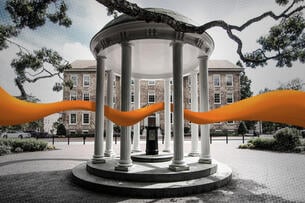 An orange band weaves through the Old Well columns located on the University of North Carolina at Chapel Hill's campus.