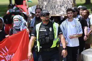 Campus police at the University of Central Florida walk amid student protesters.