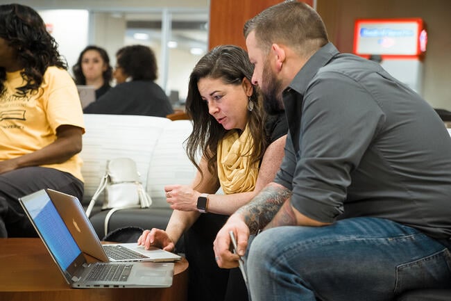 Two adult learners at Wichita State University in Kansas work on their laptops.